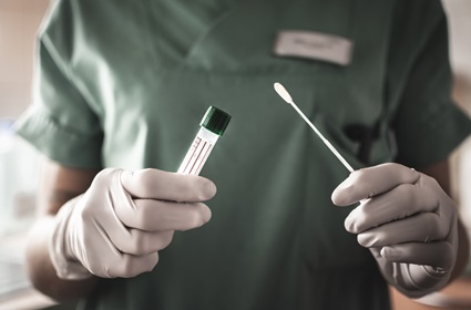 Healthcare worker holding coronavirus testing swab